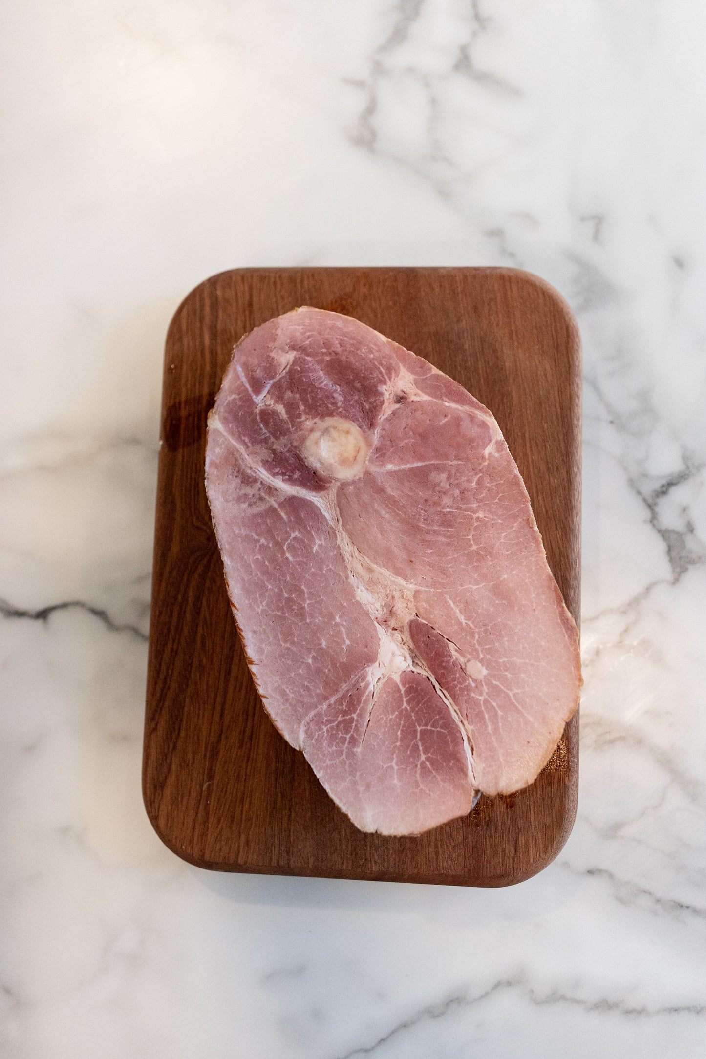 Frozen Just Pork Ham on cutting board; Healthy pork options delivered from a local farm