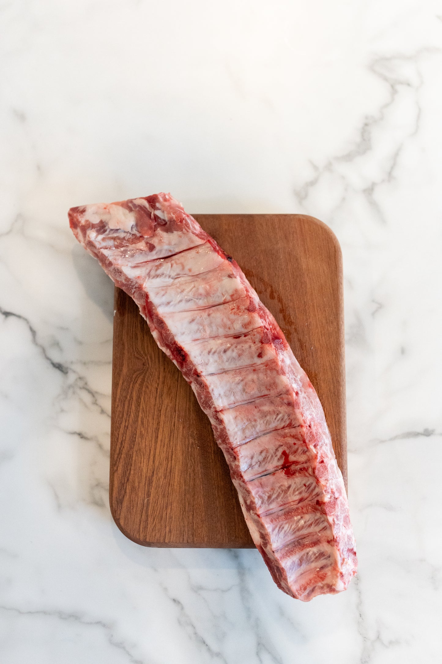Baby Back ribs raw on a cutting board