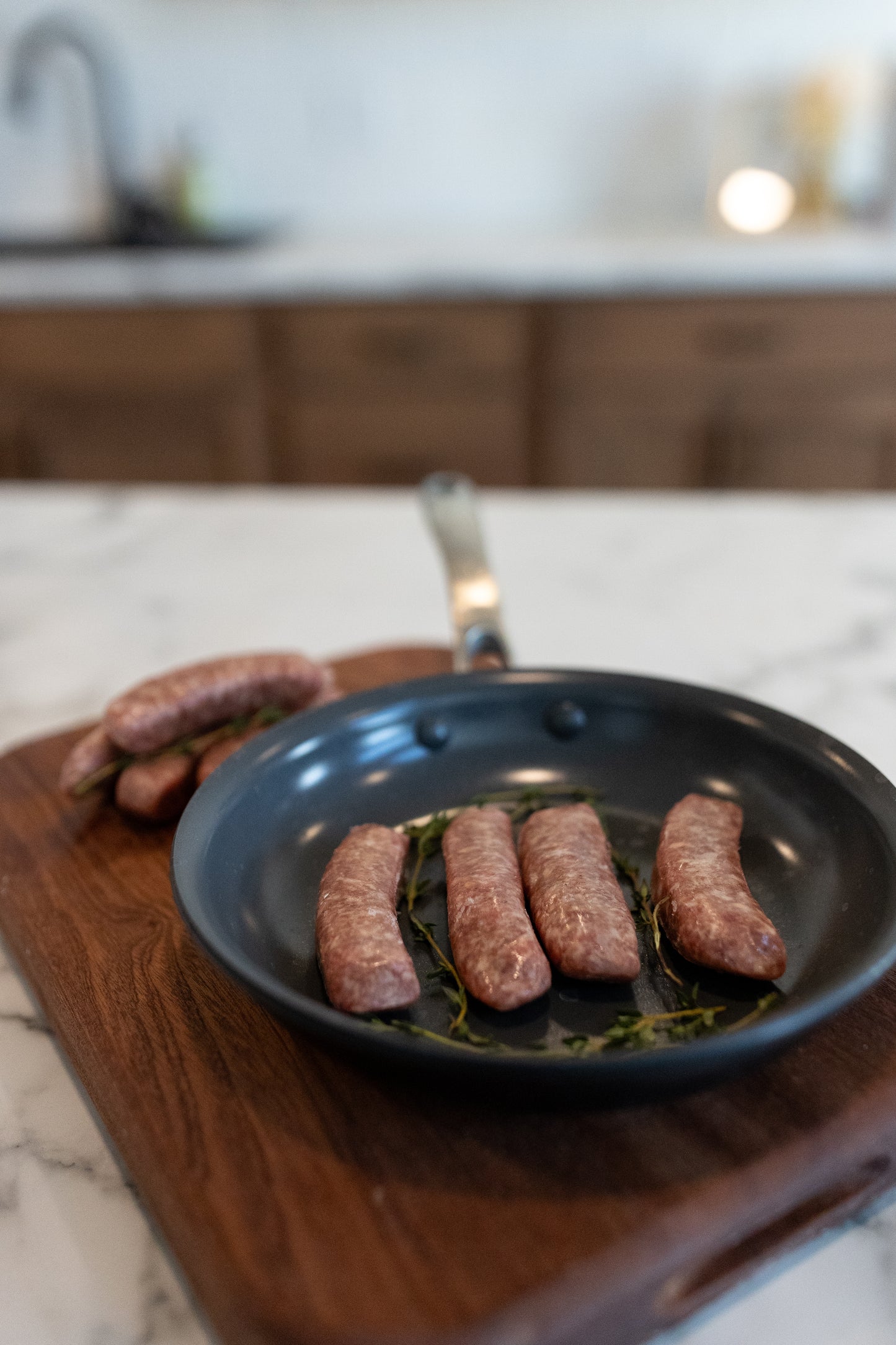 Sausage links in a pan; Clean, locally raised pork ready to cook