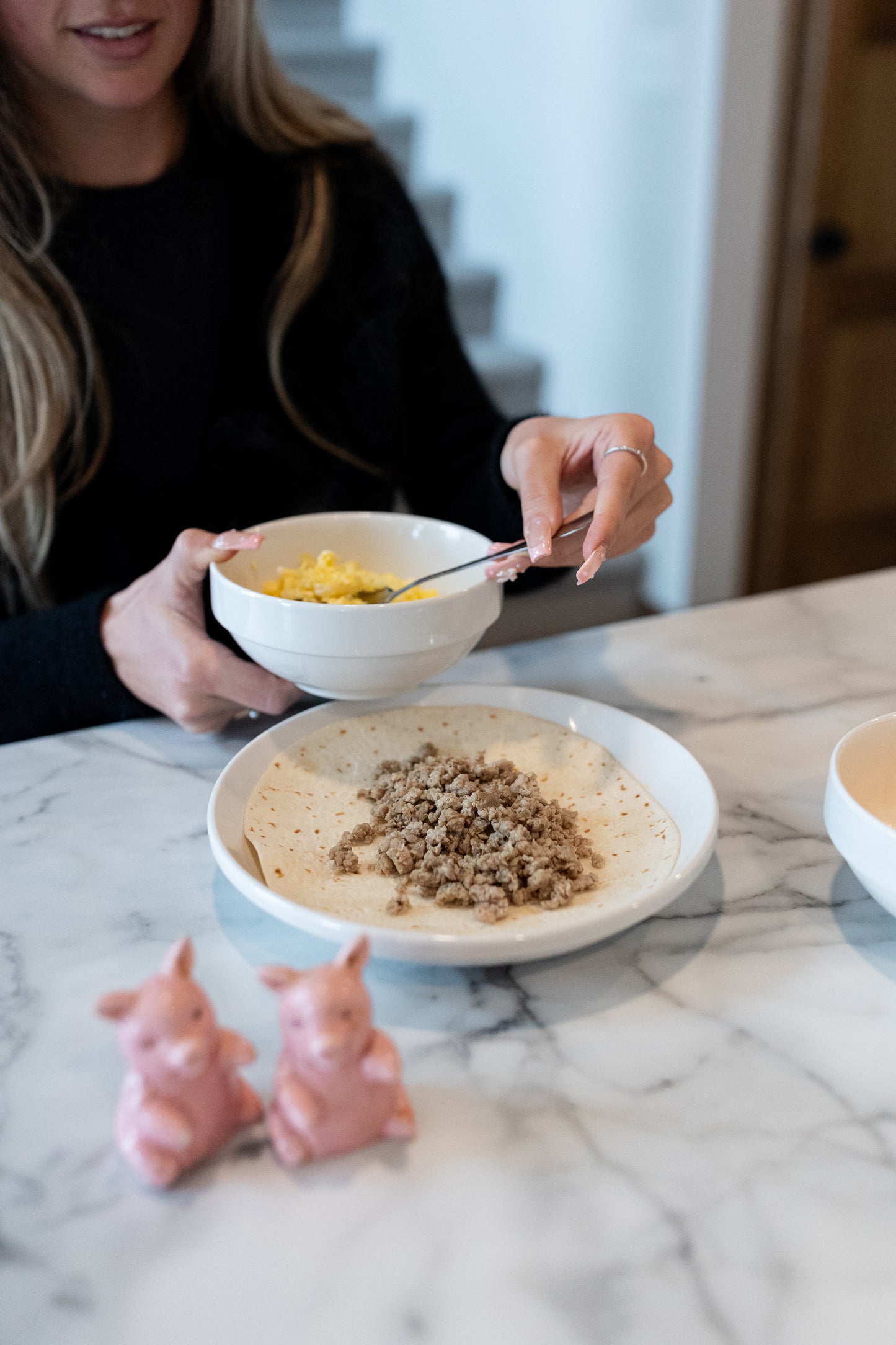 Women making a breakfast pork taco
