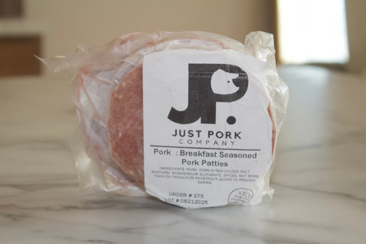 Packaged pork patties from Just Pork Company on a marble surface.
