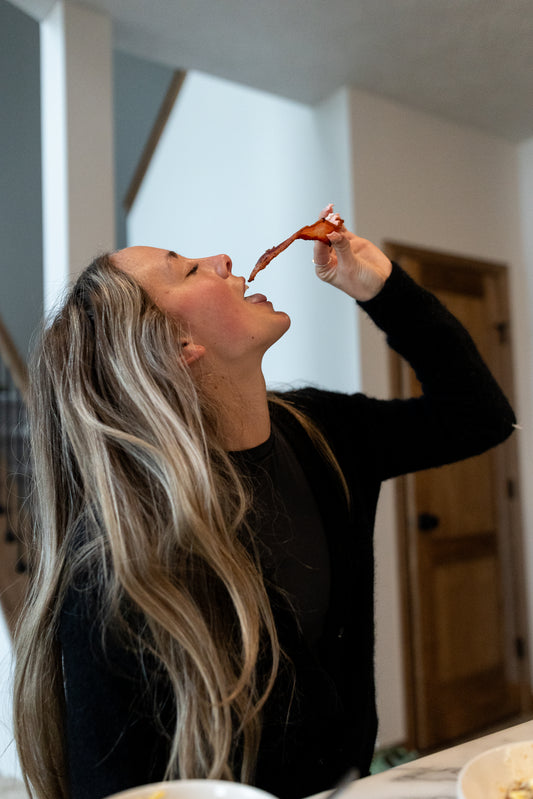 Women enjoying a slice of farm fresh bacon from adrian minnesota